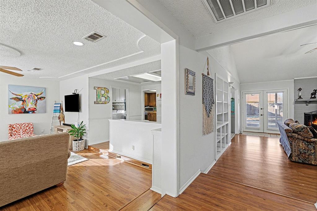 6013 Robin Drive Watauga, TX 76148 - Photo 5 of 30 Hall with a textured ceiling and wood finished floors