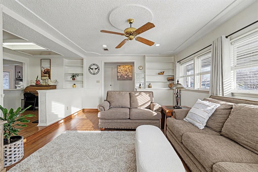 6013 Robin Drive Watauga, TX 76148 - Photo 7 of 30 Living room with built in features, a textured ceiling, ceiling fan, and wood finished floors
