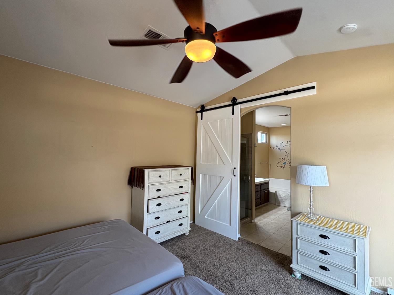 Undisclosed Address Bakersfield, CA 93311 - Photo 13 of 19 a bedroom with a bed and a chandelier