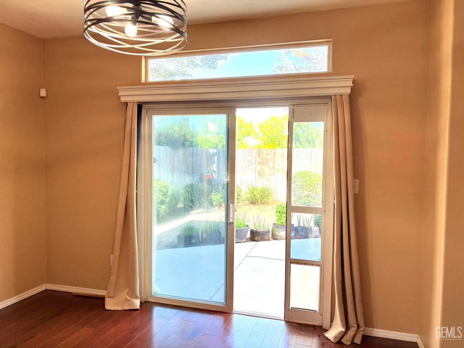 Undisclosed Address Bakersfield, CA 93311 - Photo 7 of 19 a view of a livingroom with wooden floor and a large window