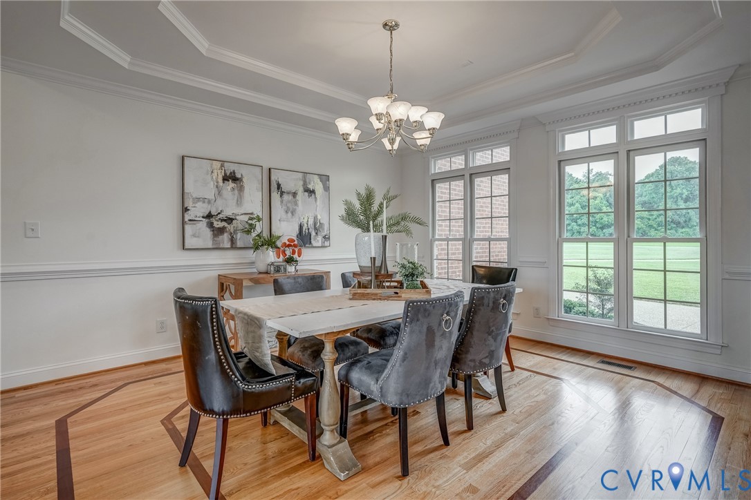 15154 Locust Level Drive Doswell, VA 23047 - Photo 18 of 48 a view of a dining room with furniture a chandelier and wooden floor