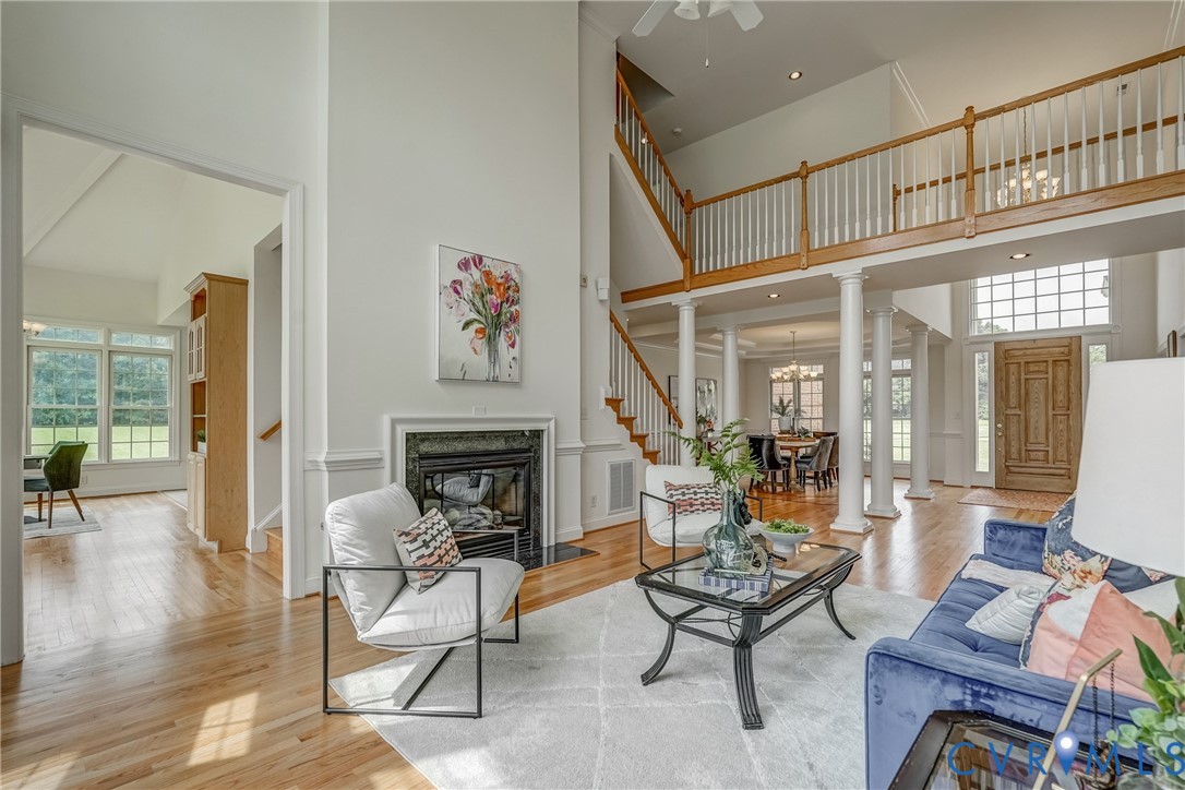 15154 Locust Level Drive Doswell, VA 23047 - Photo 30 of 48 a living room with furniture a fireplace and a dining table with wooden floor