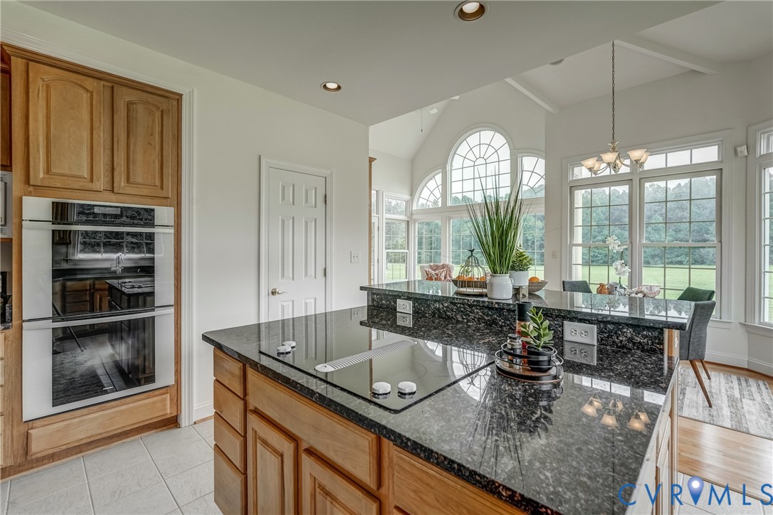 15154 Locust Level Drive Doswell, VA 23047 - Photo 35 of 48 a kitchen with a sink granite counter tops a large window and cabinets