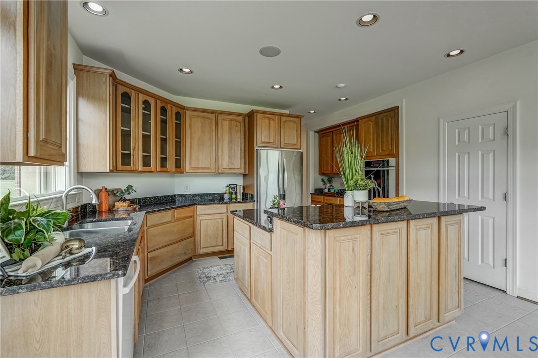 15154 Locust Level Drive Doswell, VA 23047 - Photo 36 of 48 a kitchen with stainless steel appliances kitchen island granite countertop a sink and cabinets