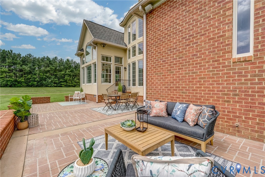 15154 Locust Level Drive Doswell, VA 23047 - Photo 10 of 48 a view of a patio with couches and a table and chairs with garden view