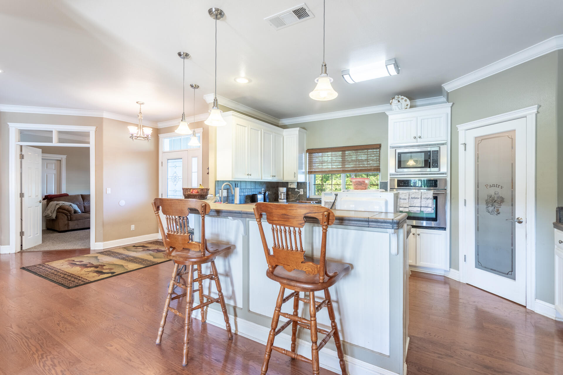 11847 Oak Run Road Oak Run, CA 96069 - Photo 12 of 54 a kitchen with stainless steel appliances kitchen island granite countertop a refrigerator a stove a kitchen island with a dining table and chairs