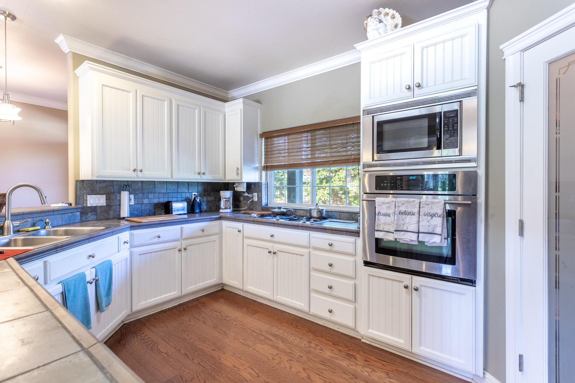 11847 Oak Run Road Oak Run, CA 96069 - Photo 14 of 54 a kitchen with stainless steel appliances granite countertop a stove microwave and cabinets