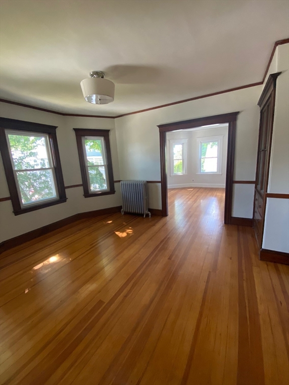 14 Welton Road Boston, MA 02132 - Photo 20 of 31 an empty room with wooden floor and windows