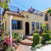 a front view of a house with a lots of potted plants