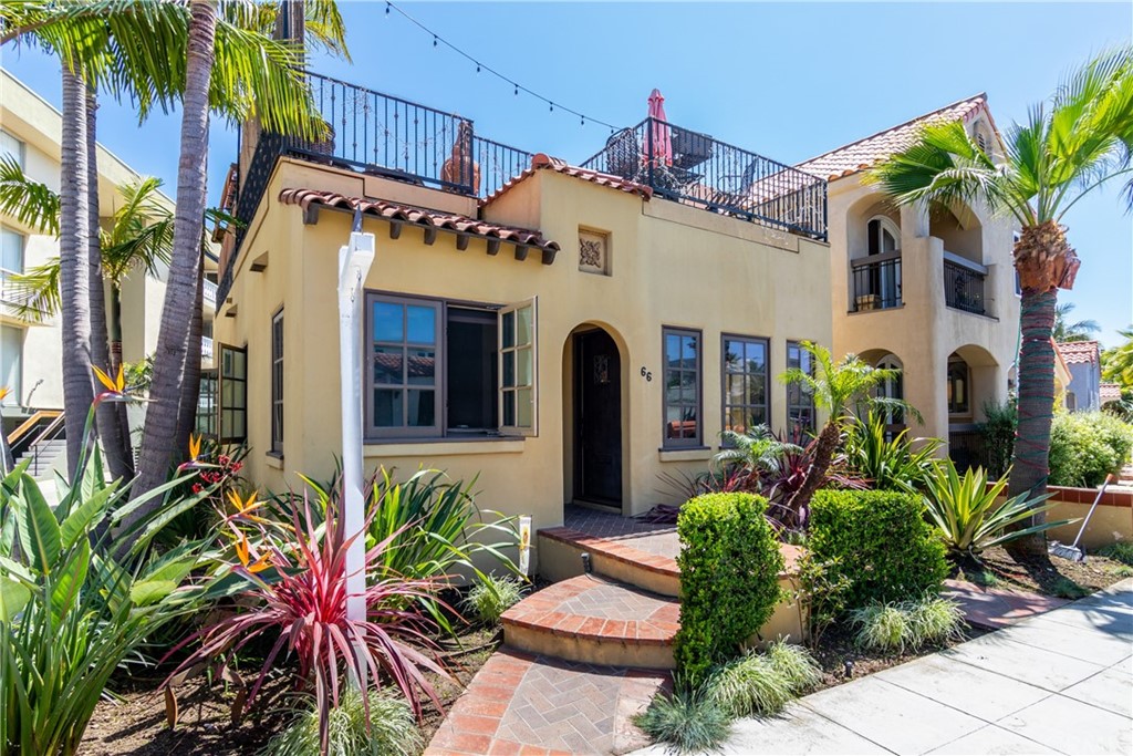 66 Corinthian Walk Long Beach, CA 90803 - Photo 1 of 26 a front view of a house with a lots of potted plants