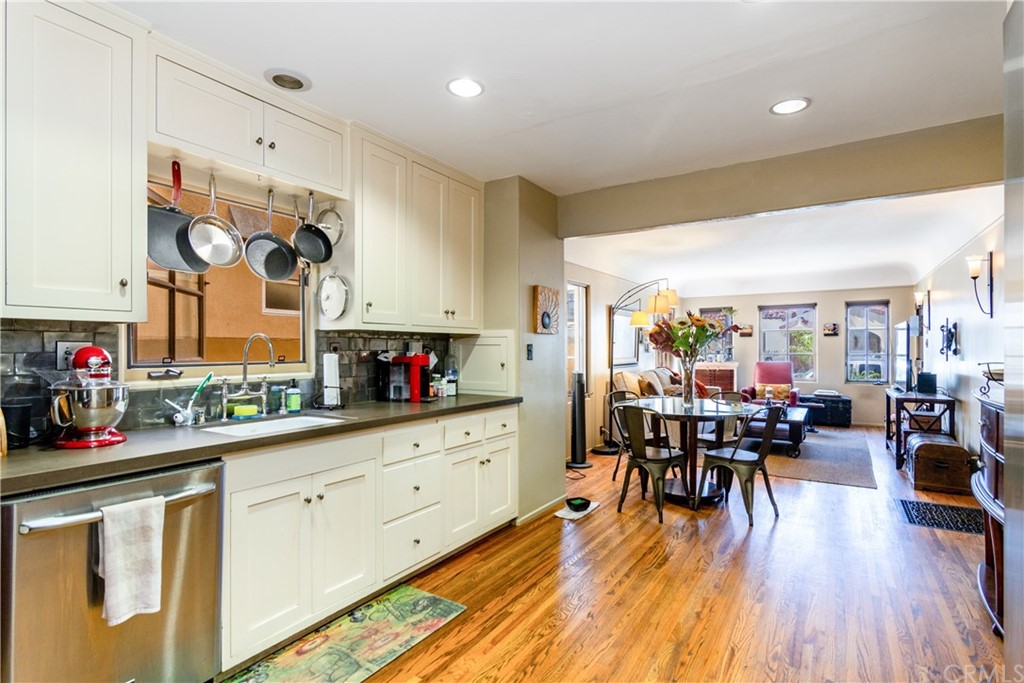 66 Corinthian Walk Long Beach, CA 90803 - Photo 11 of 26 a kitchen with stainless steel appliances granite countertop a stove and cabinets with wooden floor