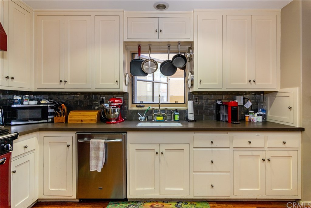 66 Corinthian Walk Long Beach, CA 90803 - Photo 12 of 26 a kitchen with white cabinets and window