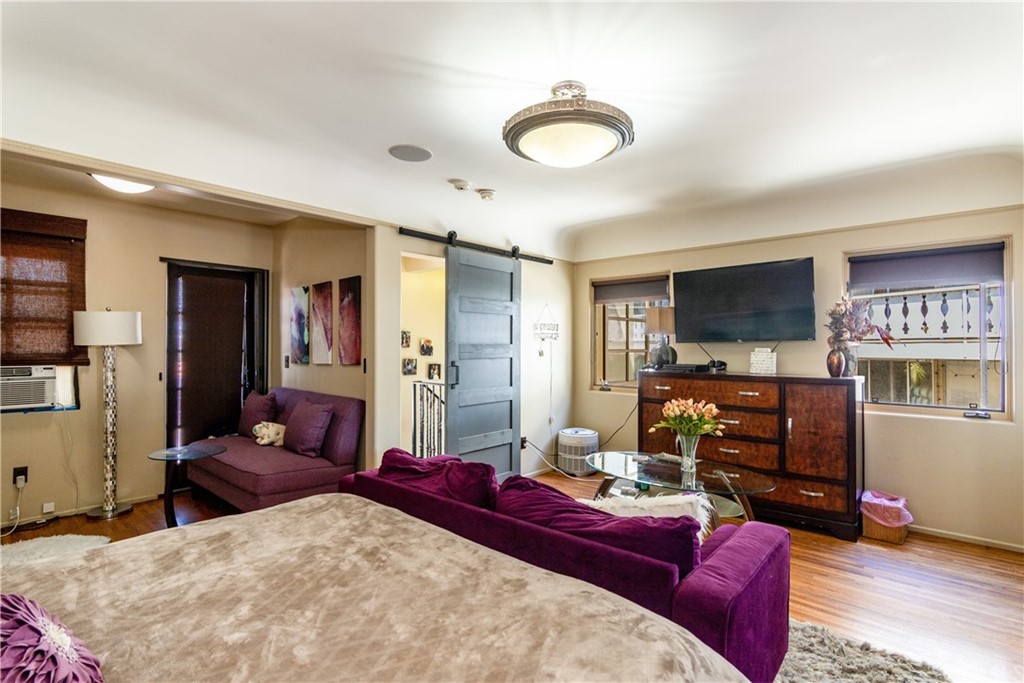 66 Corinthian Walk Long Beach, CA 90803 - Photo 16 of 26 a bedroom with furniture and a flat screen tv