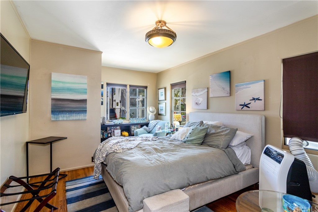 66 Corinthian Walk Long Beach, CA 90803 - Photo 7 of 26 a bedroom with a bed and wooden floor