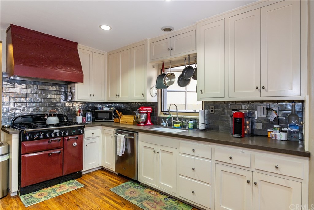 66 Corinthian Walk Long Beach, CA 90803 - Photo 10 of 26 a kitchen with stainless steel appliances granite countertop a stove and cabinets