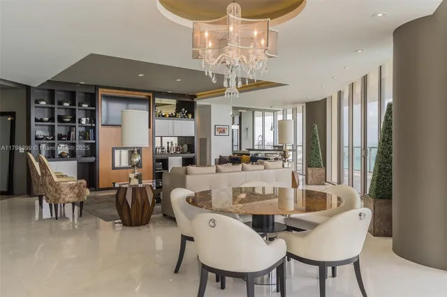 a view of a dining room with furniture and chandelier