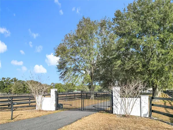 a view of a park with iron fence