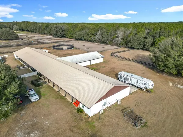 a view of a terrace with a floor to ceiling window and outdoor kitchen