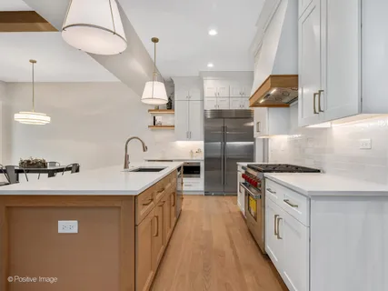 a kitchen with a sink a stove and chairs