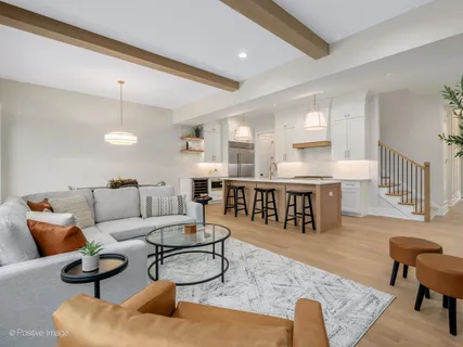 a living room with furniture and kitchen view