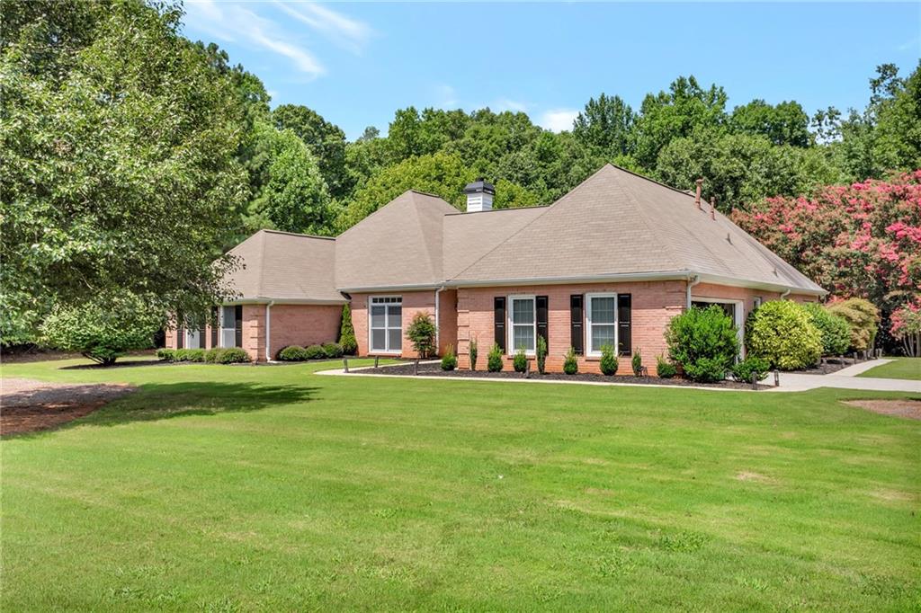 145 Springfield Creek Road Alpharetta, GA 30004 - Photo 1 of 27 a white house sitting in middle of the grass