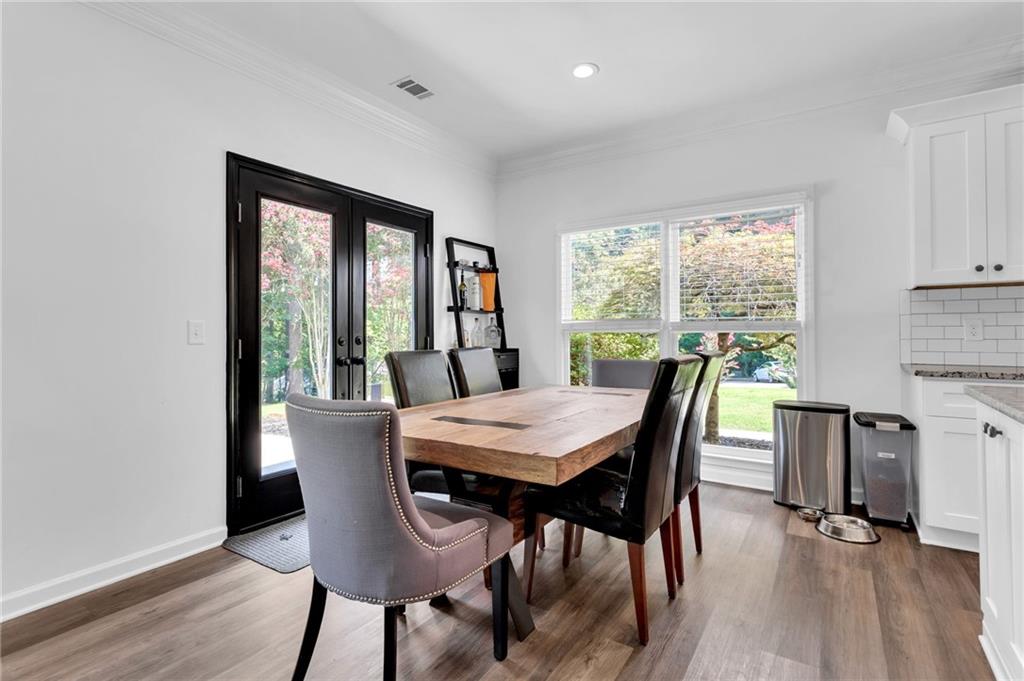 145 Springfield Creek Road Alpharetta, GA 30004 - Photo 11 of 27 a view of a dining room with furniture window and wooden floor