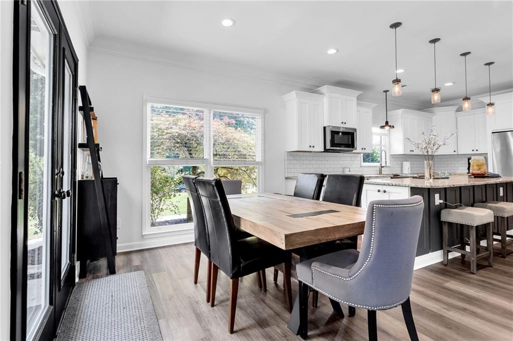 145 Springfield Creek Road Alpharetta, GA 30004 - Photo 12 of 27 a kitchen with kitchen island a dining table and chairs