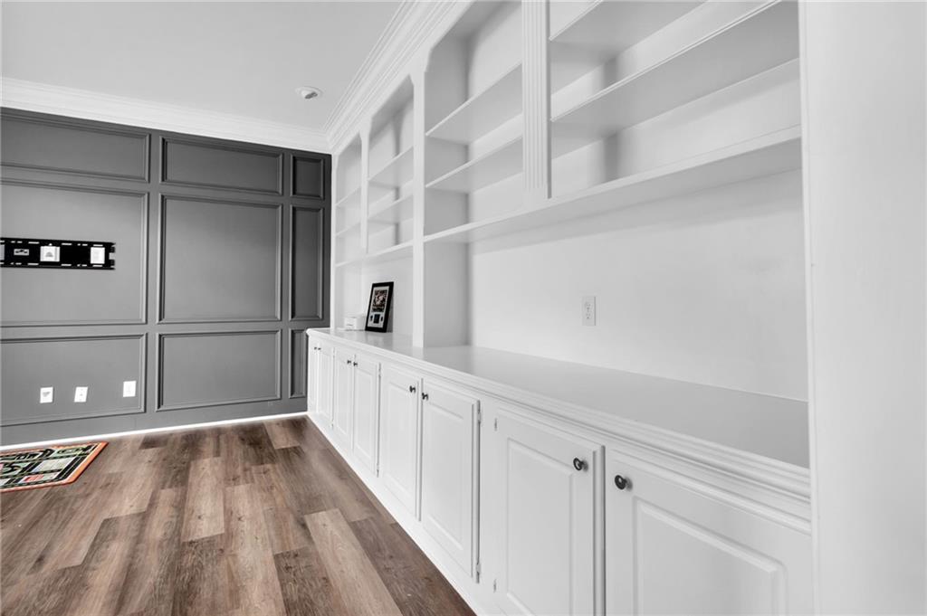 145 Springfield Creek Road Alpharetta, GA 30004 - Photo 15 of 27 a hallway with white cabinets and wooden floor