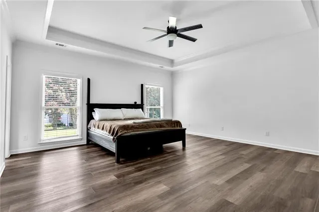 a bathroom with double vanity and a mirror