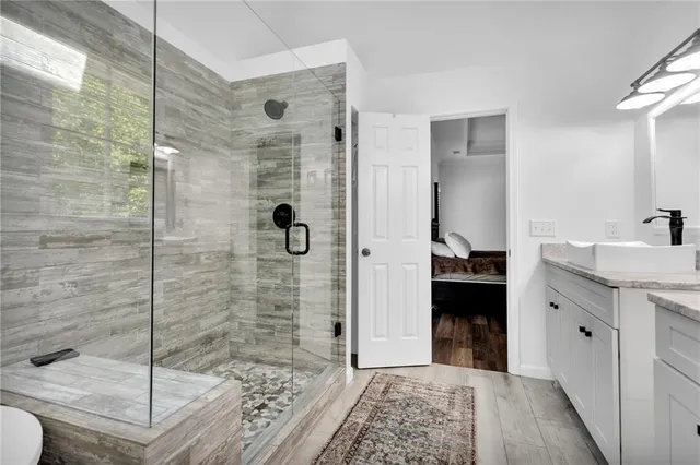 a white bath tub sitting in a bathroom next to a window