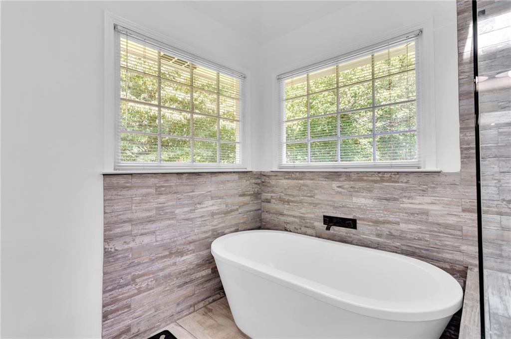 145 Springfield Creek Road Alpharetta, GA 30004 - Photo 20 of 27 a white bath tub sitting in a bathroom next to a window