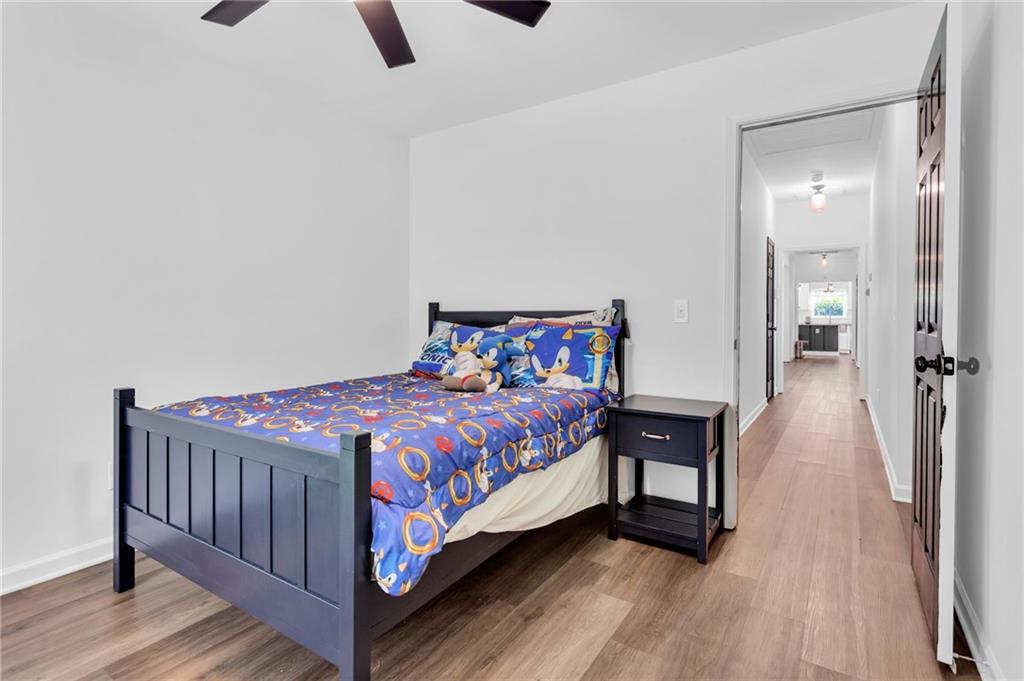 145 Springfield Creek Road Alpharetta, GA 30004 - Photo 23 of 27 a bedroom with a bed and wooden floor