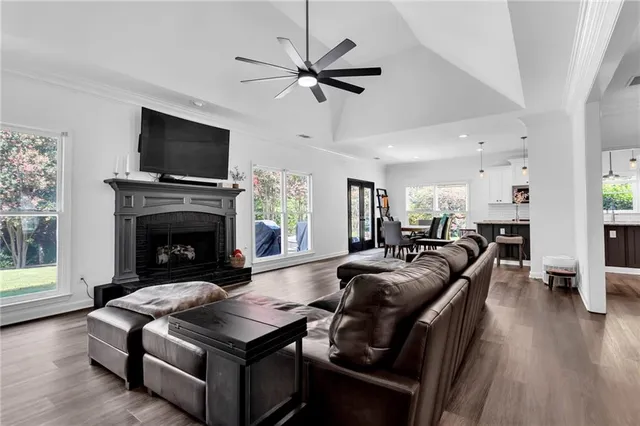 a living room with furniture a flat screen tv and a fireplace