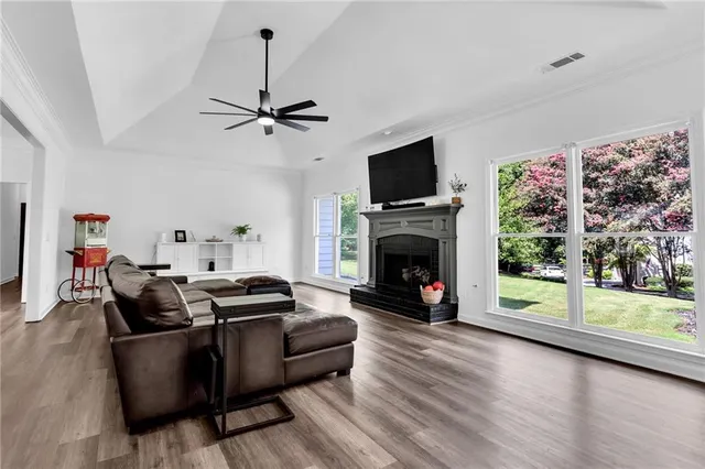 a living room with furniture a fireplace and a flat screen tv