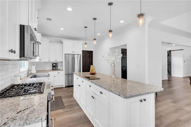 a kitchen with sink cabinets and dining table