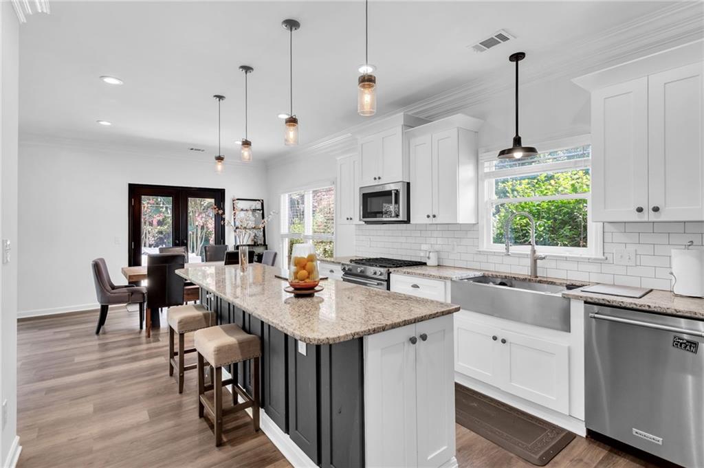 145 Springfield Creek Road Alpharetta, GA 30004 - Photo 9 of 27 a kitchen with sink cabinets and dining table