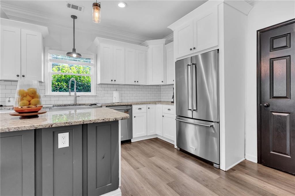 145 Springfield Creek Road Alpharetta, GA 30004 - Photo 10 of 27 a kitchen with stainless steel appliances granite countertop a refrigerator sink and cabinets