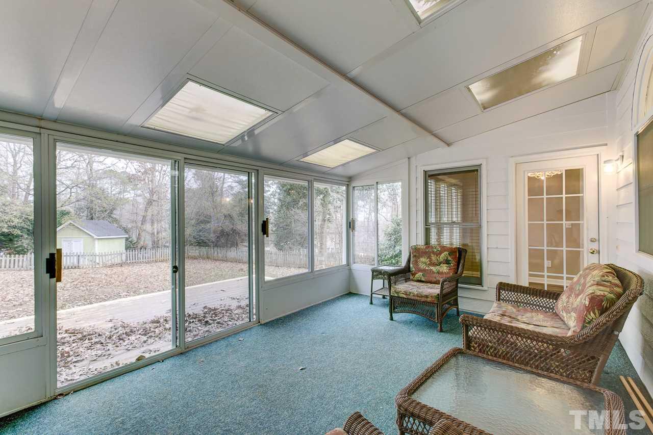 1432 Turner Farms Road Garner, NC 27529 - Photo 11 of 25 a living room with furniture and floor to ceiling windows