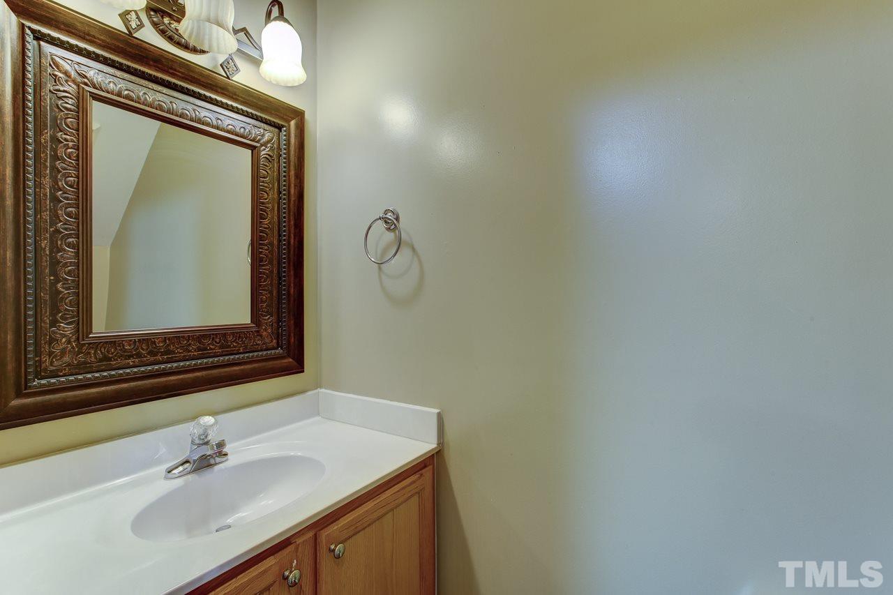 1432 Turner Farms Road Garner, NC 27529 - Photo 12 of 25 a bathroom with a sink vanity and a mirror