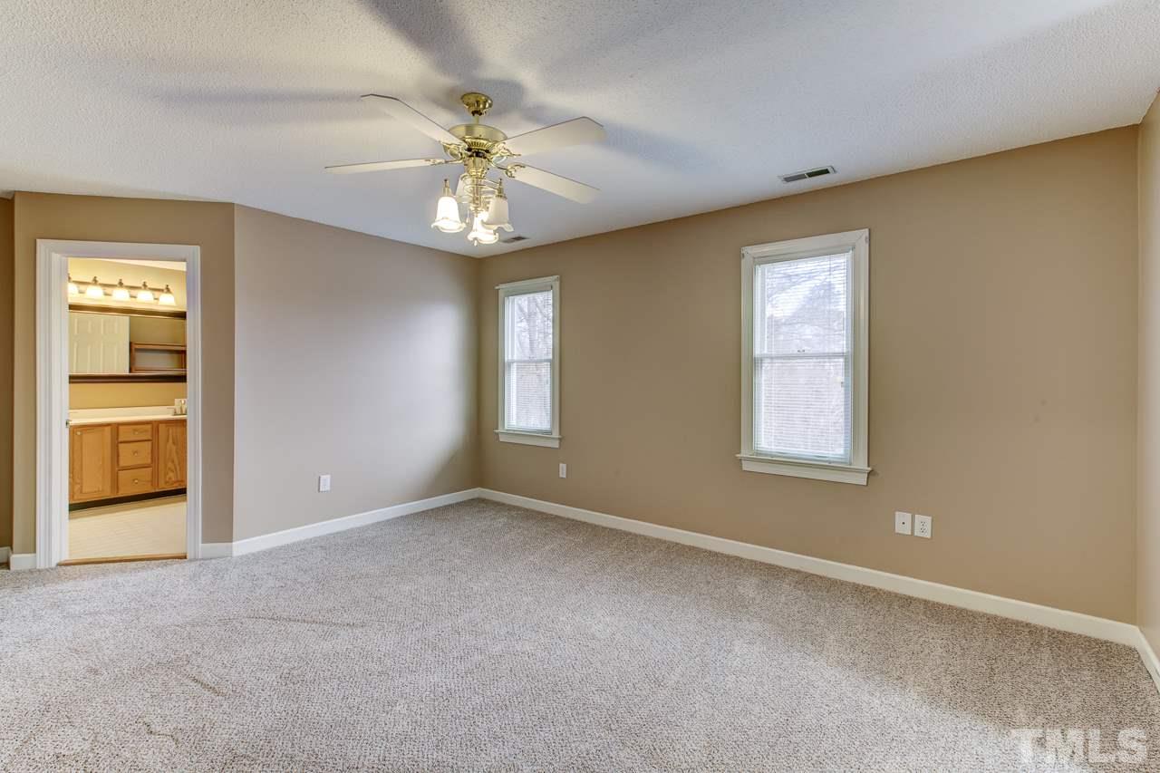 1432 Turner Farms Road Garner, NC 27529 - Photo 18 of 25 an empty room with chandelier and windows