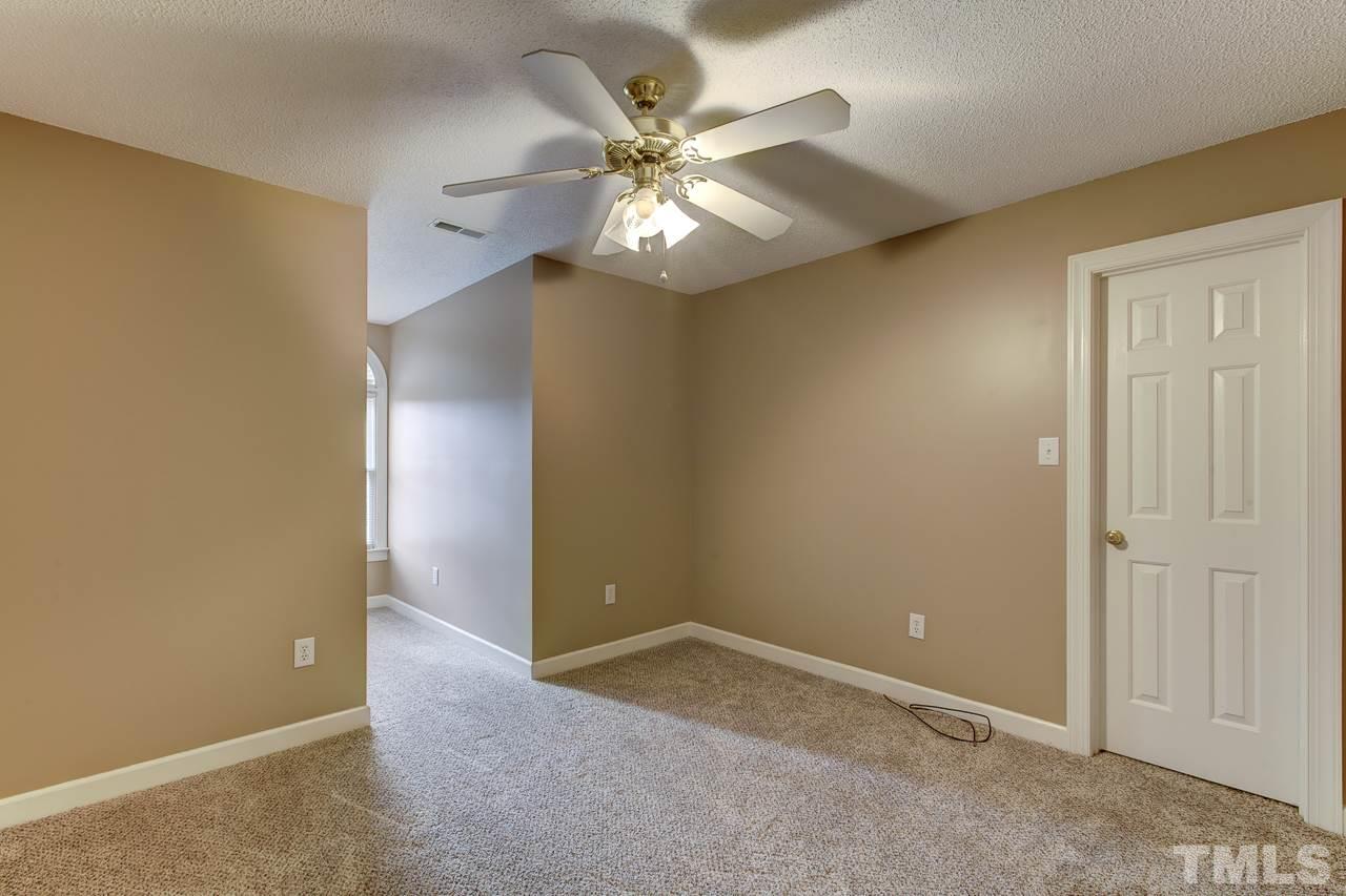 1432 Turner Farms Road Garner, NC 27529 - Photo 20 of 25 an empty room with closet and a ceiling fan