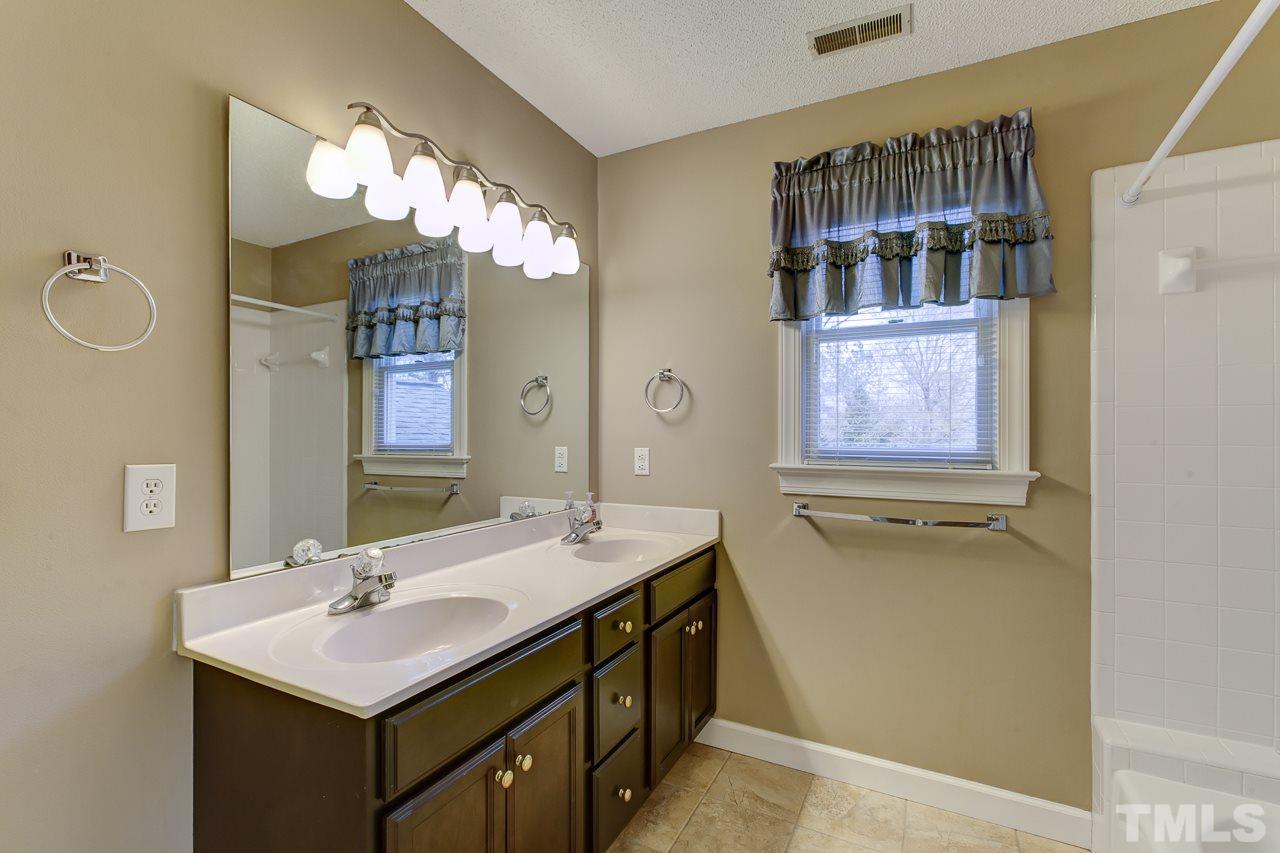 1432 Turner Farms Road Garner, NC 27529 - Photo 21 of 25 a bathroom with a sink double vanity and a mirror