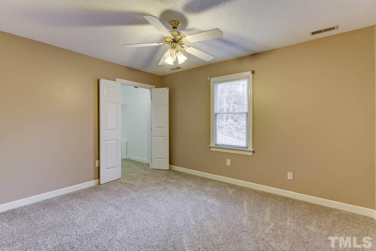 1432 Turner Farms Road Garner, NC 27529 - Photo 22 of 25 an empty room with windows and fan