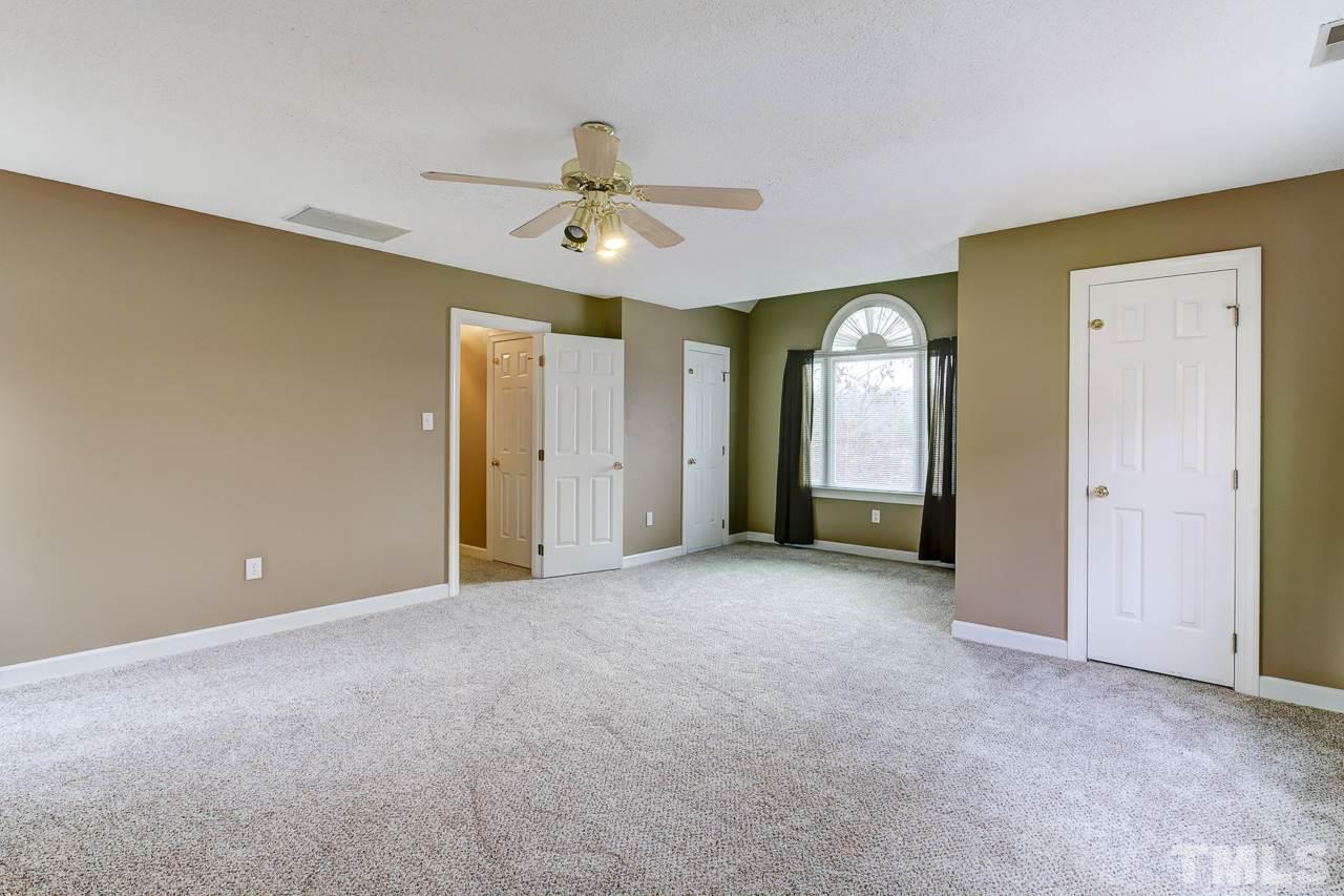 1432 Turner Farms Road Garner, NC 27529 - Photo 24 of 25 a view of an empty room with a ceiling fan