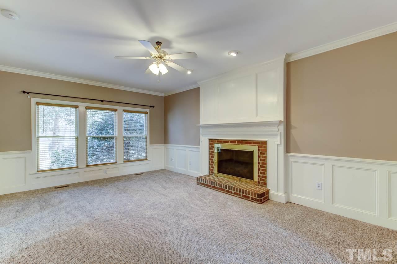 1432 Turner Farms Road Garner, NC 27529 - Photo 6 of 25 a view of an empty room with chandelier fan and fire place