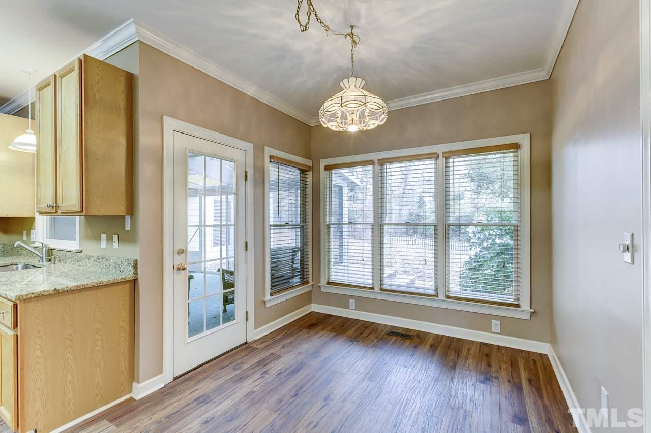 1432 Turner Farms Road Garner, NC 27529 - Photo 7 of 25 a view of an empty room with a window and wooden floor