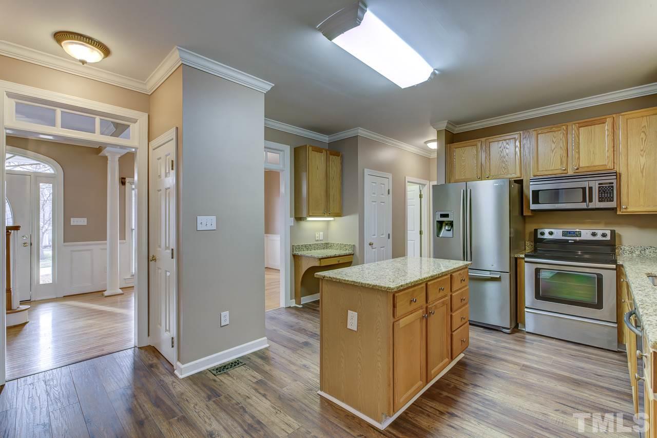 1432 Turner Farms Road Garner, NC 27529 - Photo 8 of 25 a kitchen with a refrigerator a stove top oven and wooden floor