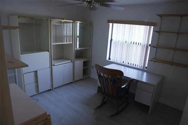 a workspace room with furniture and wooden floor