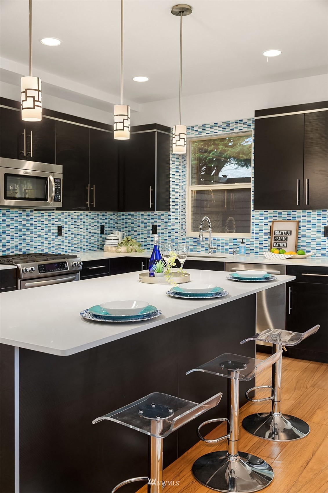 8000 Meridian Avenue North Seattle, WA 98103 - Photo 11 of 33 a kitchen with a sink a counter top space appliances and a view of living room