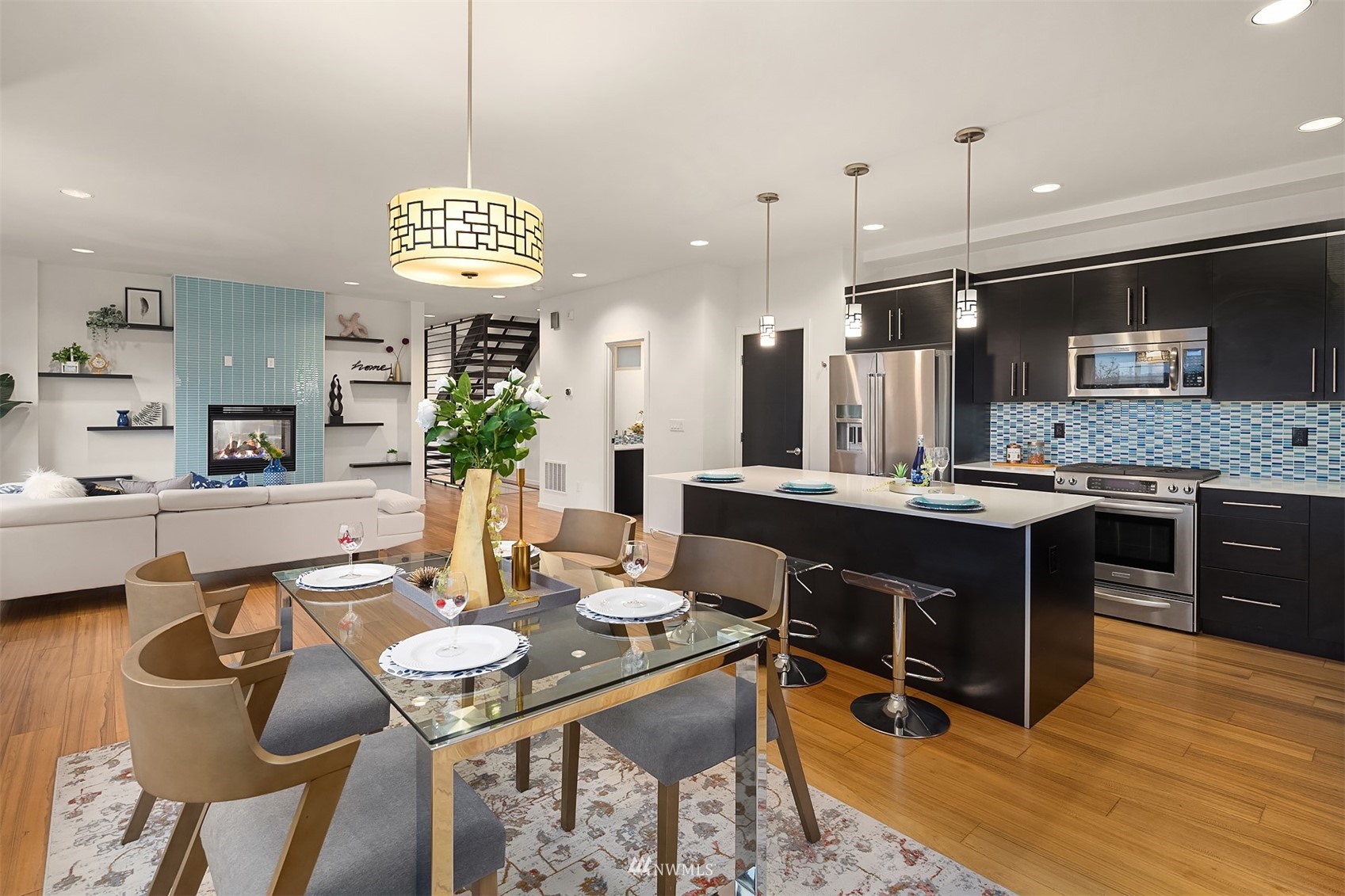 8000 Meridian Avenue North Seattle, WA 98103 - Photo 12 of 33 a kitchen with stainless steel appliances kitchen island granite countertop a table chairs and a stove